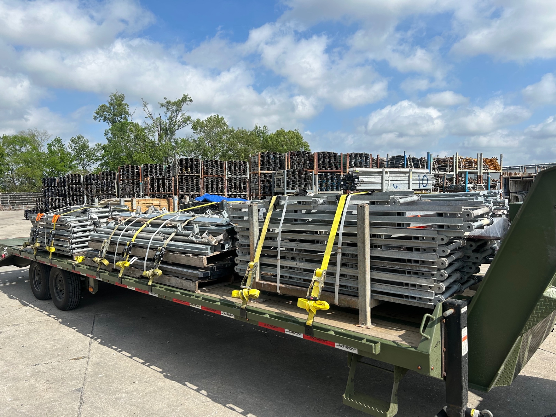 Scaffolding frames and materials loaded at a rental yard