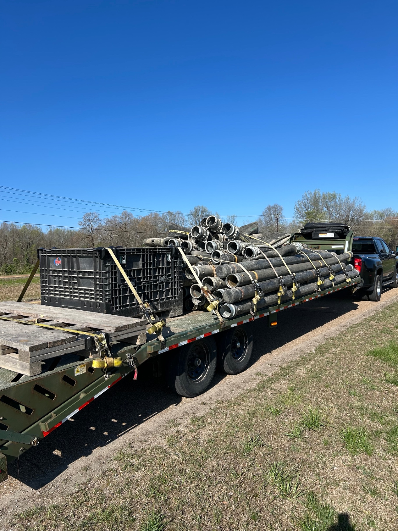 Loaded drainage and jobsite pipe materials on a flatbed trailer